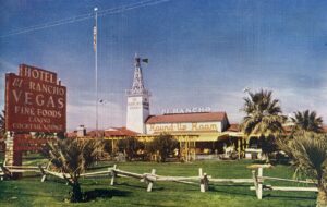 Color postcard of the outside of the El Rancho Vegas with signage for the Round-Up Room, which was the original restaurant with small dance floor. 