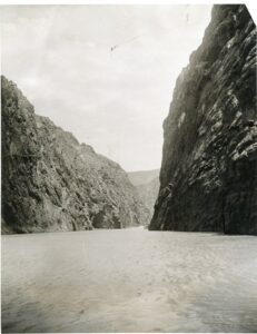 Black and white photo taken from the Colorado river looking at Black Canyon