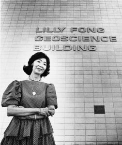 Photo of Lilly Fong in 1985 standing outside the UNLV Lilly Fong Geoscience Building named in her honor.
