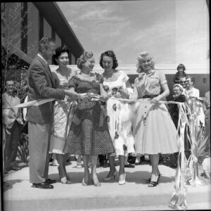 Sonja Henie cutting the ribbon to open the New Frontier
